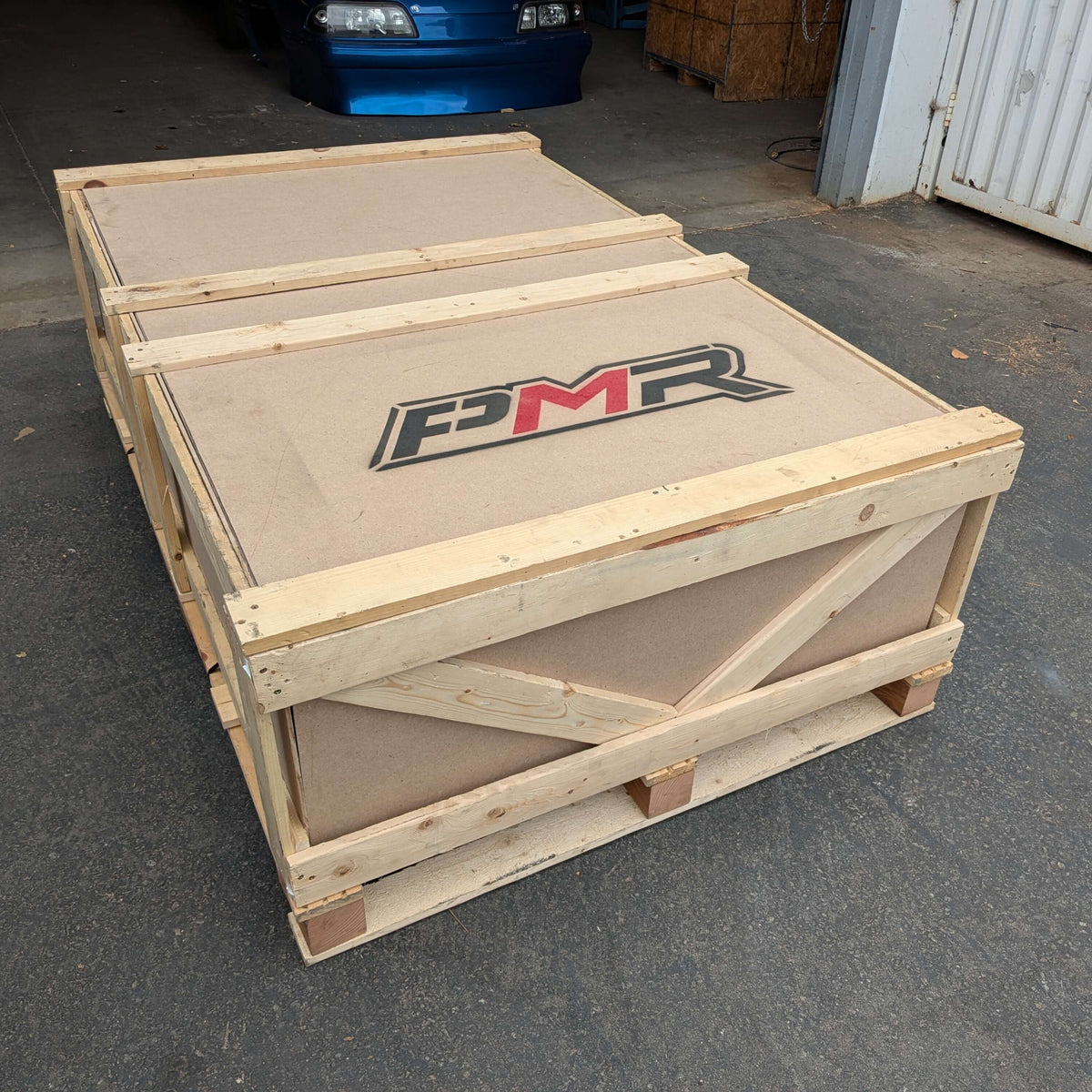 Dodge Challenger chromoly cage kit packaging in a secure wooden crate with PMR branding.