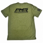 An olive green heathered t-shirt shown from the back, featuring a large black 'PMR' logo, plus a black American flag graphic on the left sleeve.