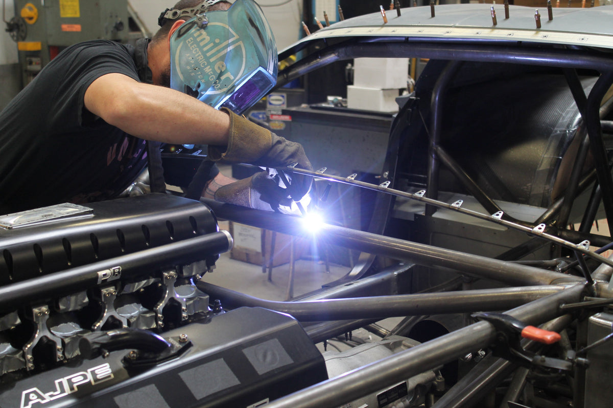 Welding metal components of a vehicle in an industrial setting