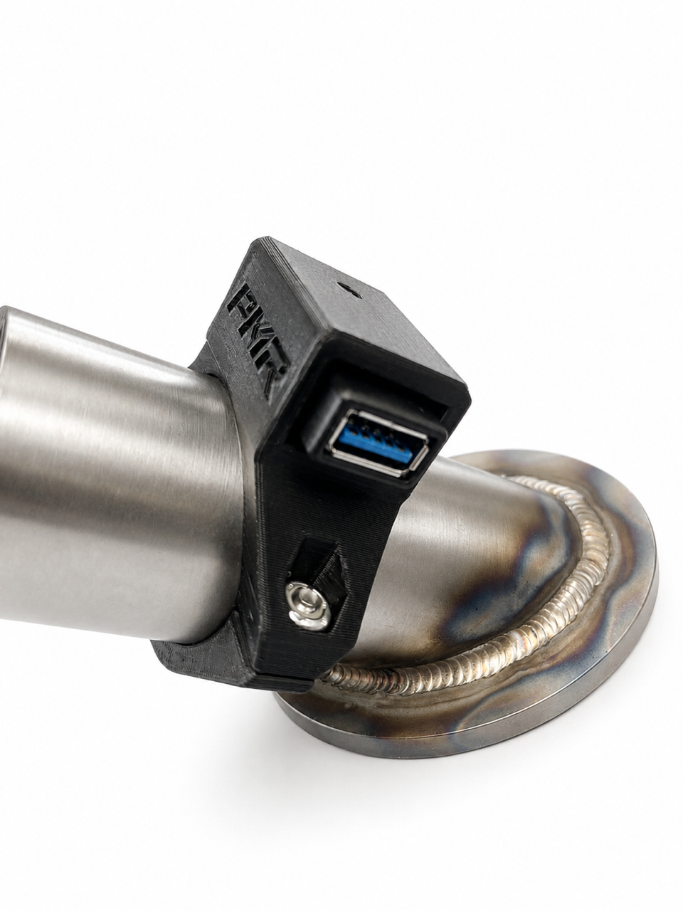 A close-up of a black clamp-mounted USB-C charging port adapter attached to a brushed metal cylindrical component, with a circular welded base and a visible USB-C port showing blue interior accents.